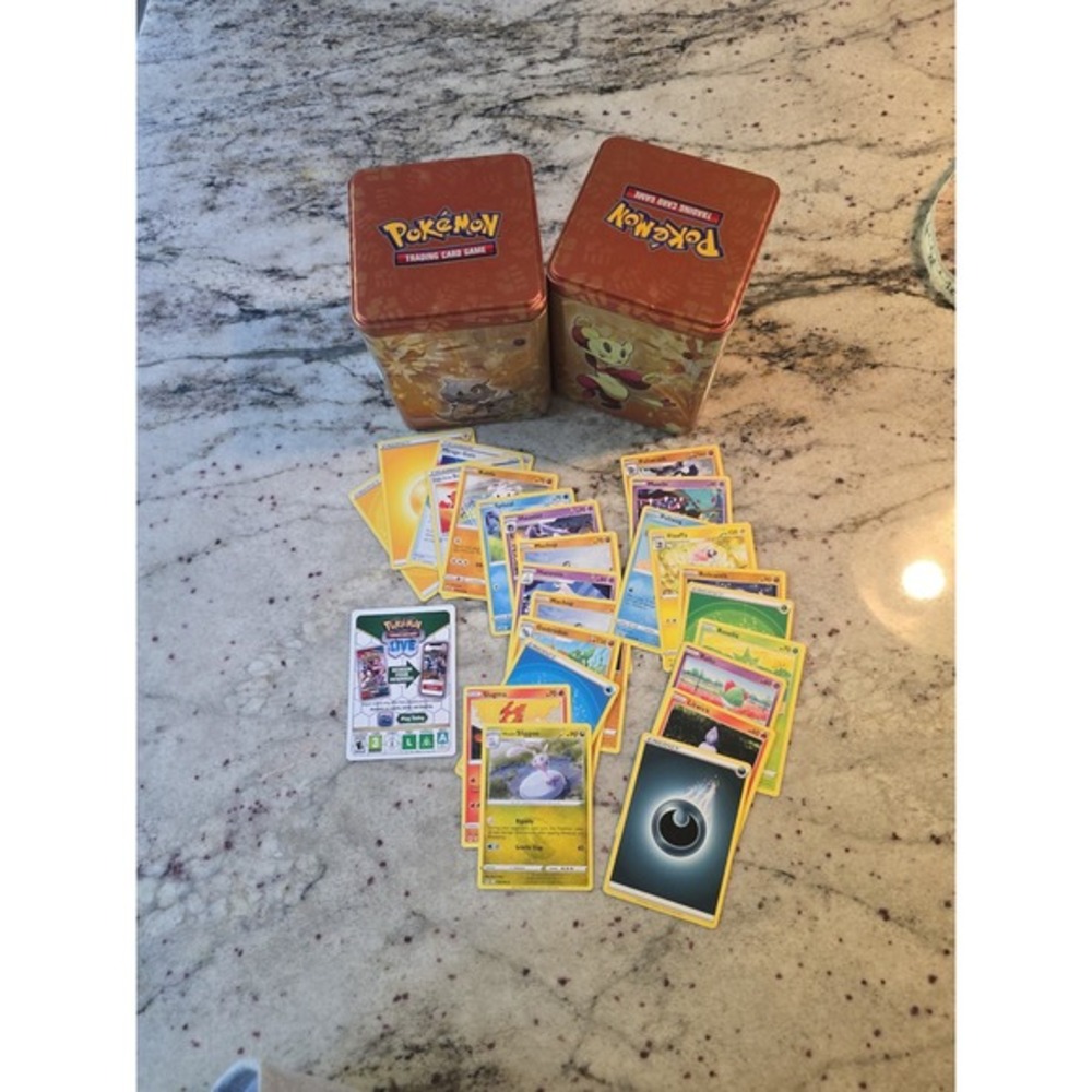 Pokémon stack em. High tins with cards 2tins